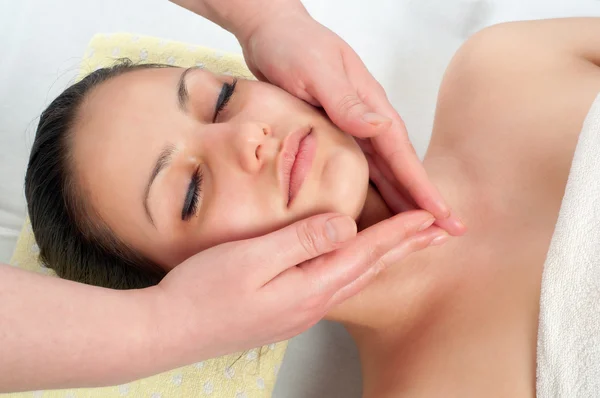 Beautiful young women getting a face massage — Stock Photo, Image