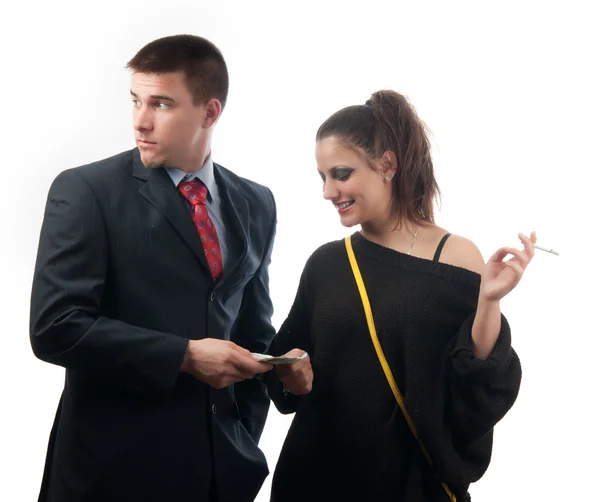Worried young businessman giving money to the lady of questionable moral — Stock Photo, Image