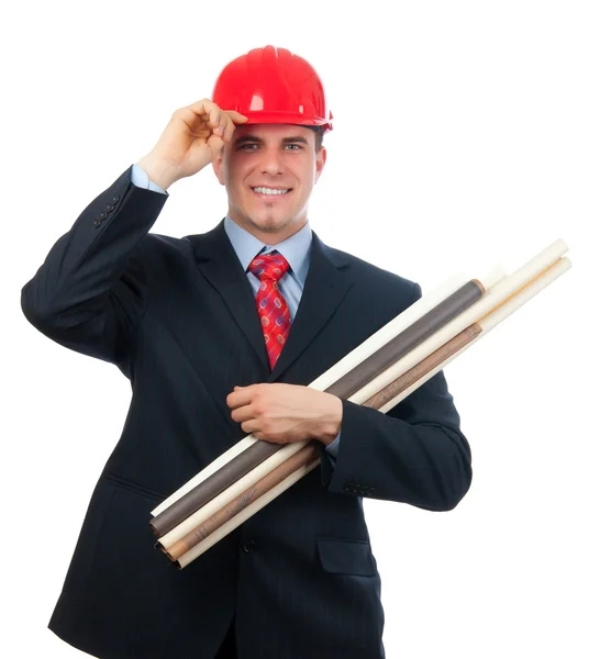 Knappe lachende ingenieur met rode helm op zijn hoofd en blauwdrukken in zijn armen geïsoleerd op wit — Stockfoto