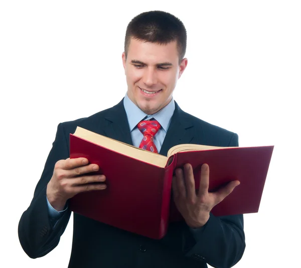 Uśmiechający się przystojny biznesmen czytanie książki na białym tle — Zdjęcie stockowe