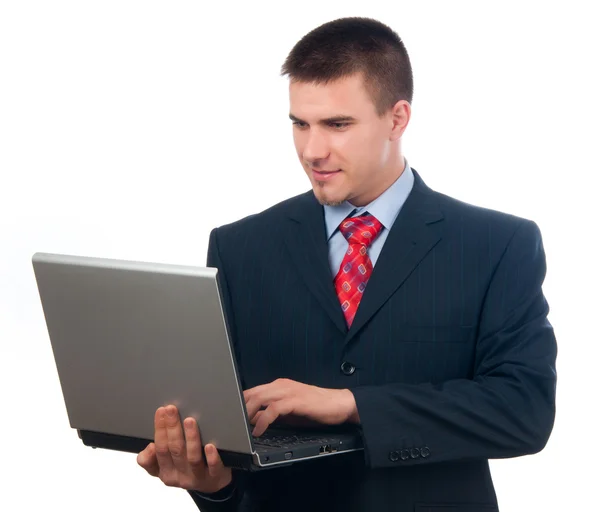 Jeune homme d'affaires attrayant travaillant sur ordinateur portable isolé sur blanc Photo De Stock