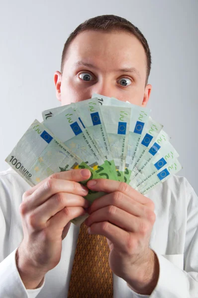 Hombre de negocios sorprendido con mucho dinero — Foto de Stock