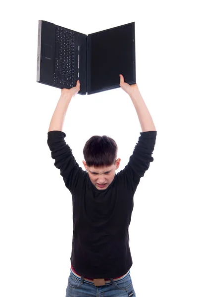Angry teenage boy throwing laptop isolated on white — Stock Photo, Image