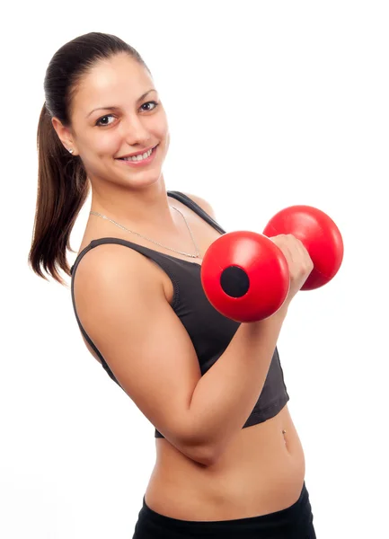 Joven mujer atractiva sonriente haciendo ejercicio con mancuerna roja aislada en blanco — Foto de Stock