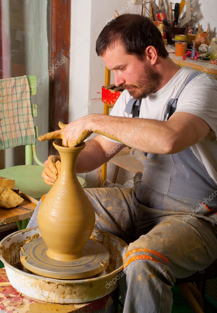 Craftsman making vase from fresh wet clay on pottery wheel — Stock