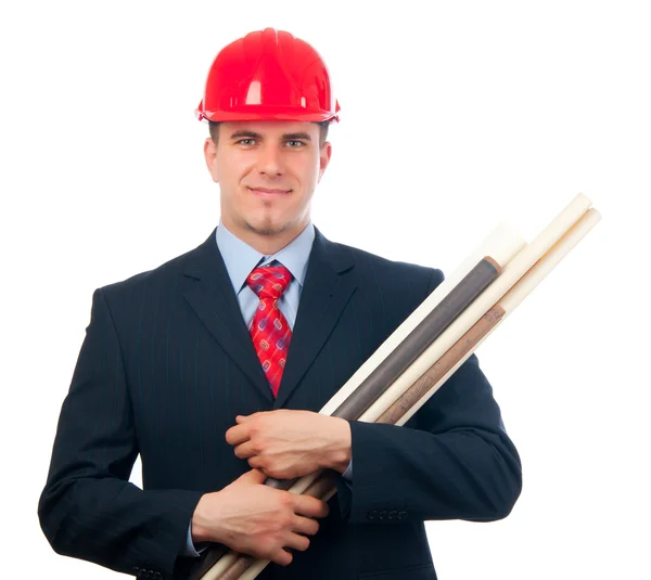 Schöner lächelnder Ingenieur mit hartem Hut auf dem Kopf und Bauplänen in den Armen, isoliert auf weiß — Stockfoto