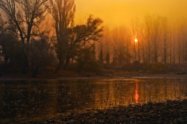 Landscape showing sunrise over the river on beautiful autumn day clipart