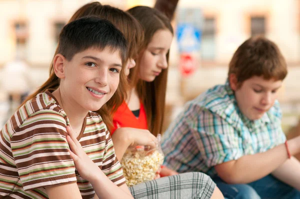Portrait of beautiful smiling teenage boy spending time together with his friends — Stock Photo, Image