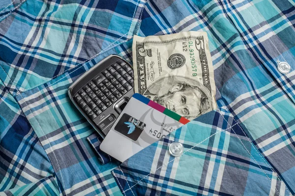 Geld, Telefon und Kreditkarte im Taschenhemd — Stockfoto