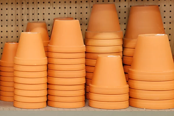 Stack of clay pots on a shelf — Stock Photo, Image