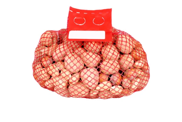 Gemischte Nüsse in einem Netzbeutel — Stockfoto