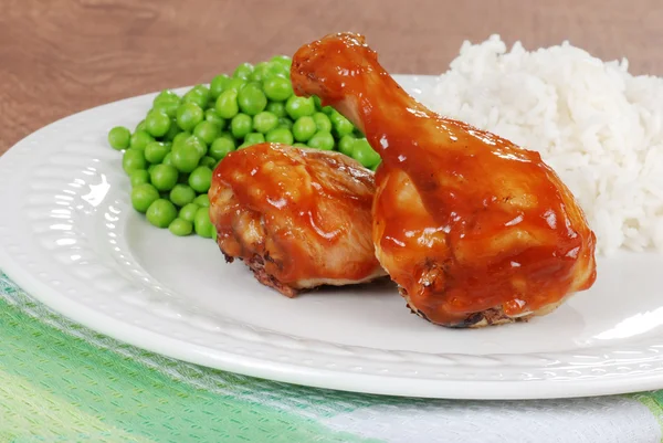 Chicken legs with peas and rice — Stock Photo, Image