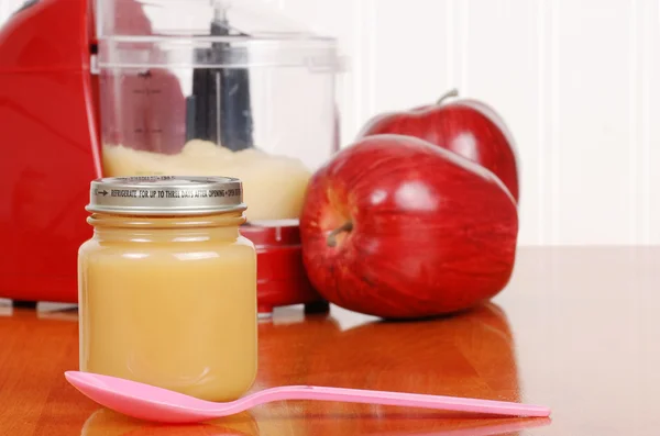 Homemade apple sauce baby food with spoon — Stock Photo, Image