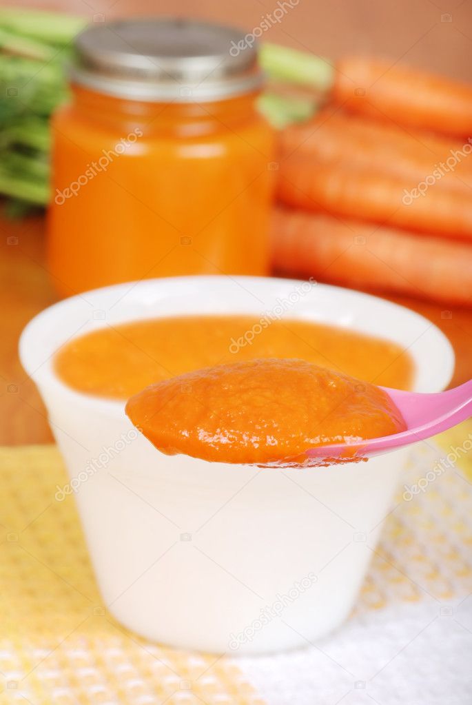 Macro carrot baby food on spoon
