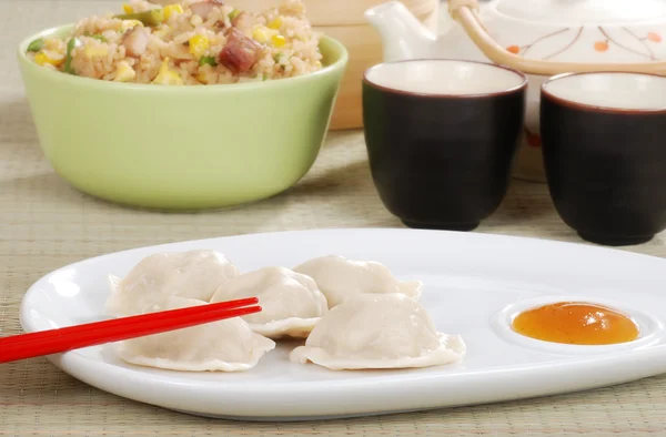 Dumpling with plum sauce and chopsticks — Stock Photo, Image
