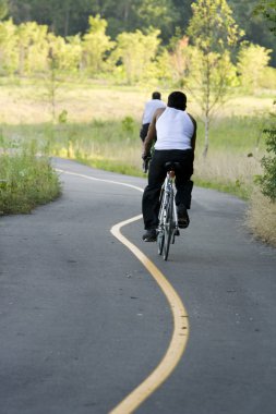 Bicycling in the park clipart