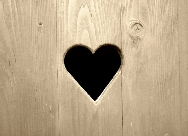 Retro detal drewniany drzwi z serca — Zdjęcie stockowe
