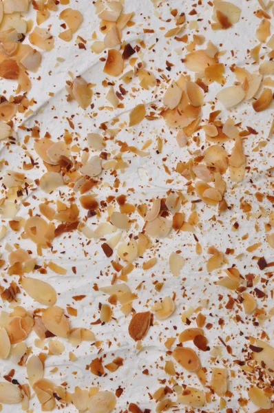 Roasted almonds on whipped cream — Stock Photo, Image