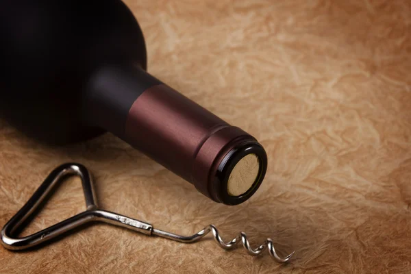 Corkscrew and bottle of wine — Stock Photo, Image