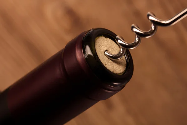 Wine bottle with a corkscrew — Stock Photo, Image