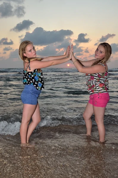 stock image Two girls blonde on the beach at sunset