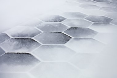 Hexagonal tiles covered with snow clipart