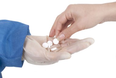 Doctor or nurse giving pills to a patient clipart