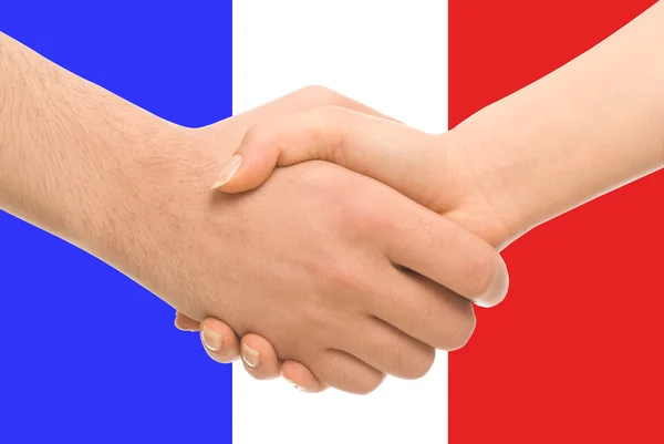 Aperto de mão com bandeira francesa como fundo Fotos De Bancos De Imagens