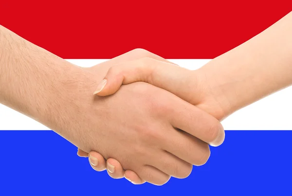 배경으로 네덜란드 국기와 악수 스톡 사진