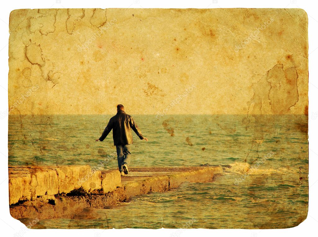 The man on the stone pier in the sea. Old postcard.