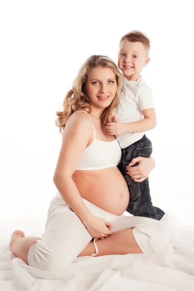 Beautiful pregnant woman with her son. Isolated on white backgro — Stock Photo, Image