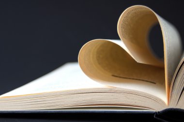 Pages of a book curved into a heart clipart