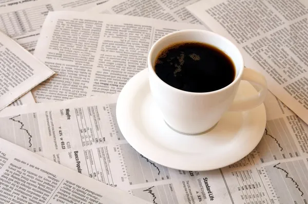 Coffee over newspaper — Stock Photo, Image