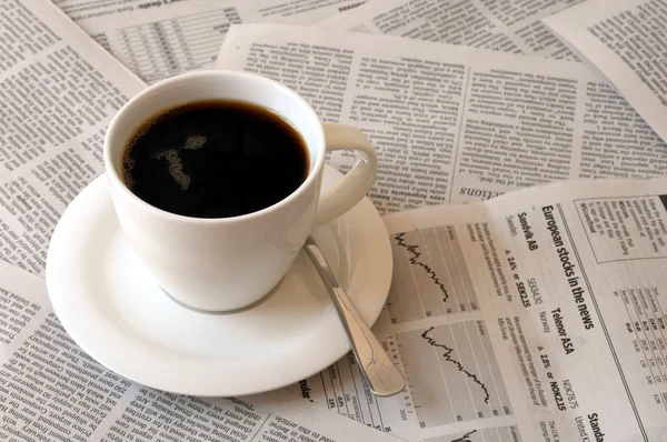 stock image Coffee over newspaper