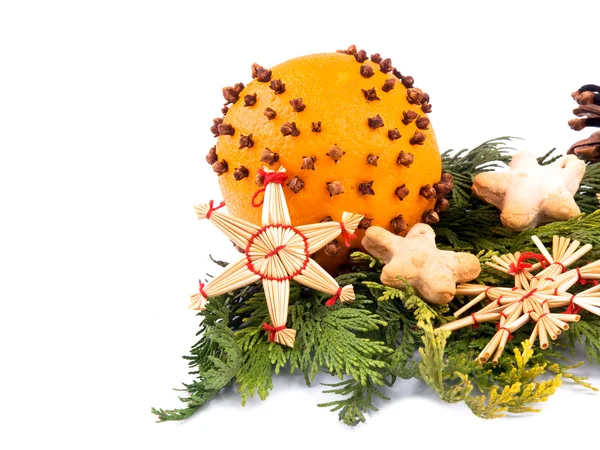 Orange with cloves and christmas ornaments — Stock Photo, Image
