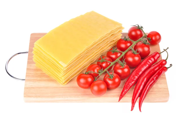 stock image Lasagna pasta with tomato and pepper on cutting board