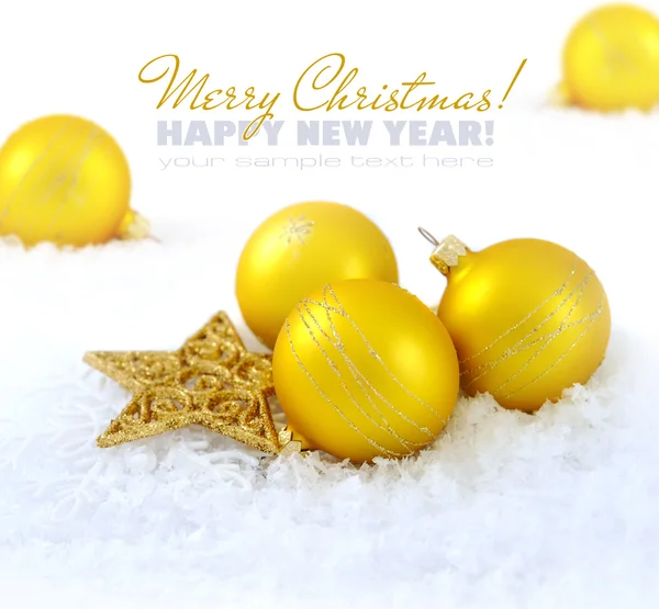 Christmas composition is with gold balls and by a star on snow — Stock Photo, Image
