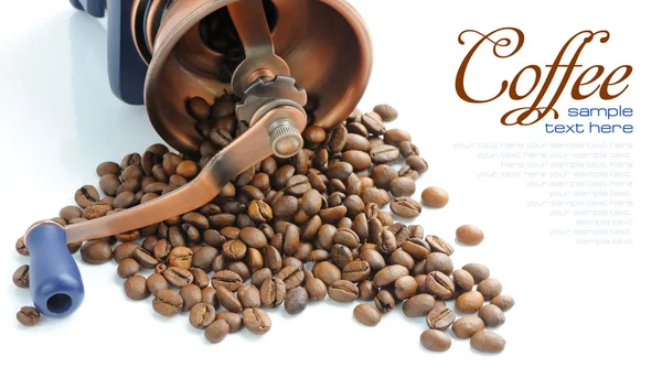 Старомодный кофемолка и жареный кофе в зернах — стоковое фото