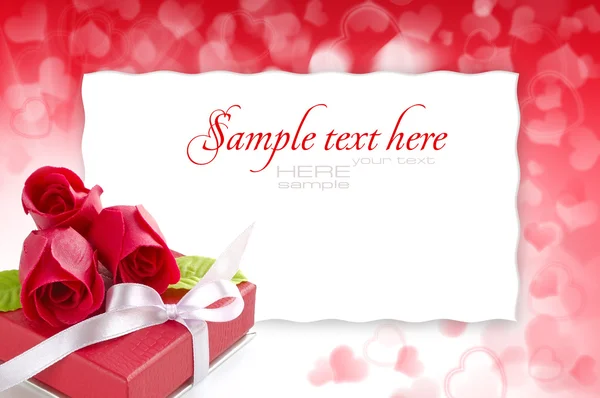 Pequeno presente vermelho com rosas no fundo festivo com espaço para — Fotografia de Stock