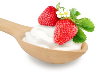 Wooden spoon is with creams and fresh strawberry on a white back clipart