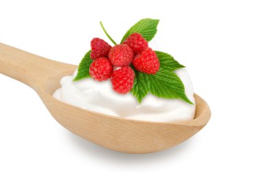 Wooden spoon is with creams and fresh raspberry on a white backg clipart