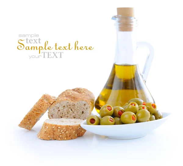 Zielone oliwki, olej, są kromki chleba na białym tle — Zdjęcie stockowe