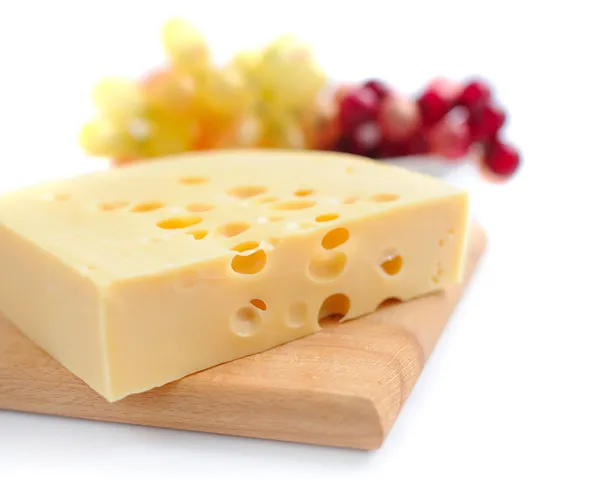 Piece of cheese on a wooden board on a white background — Stock Photo, Image