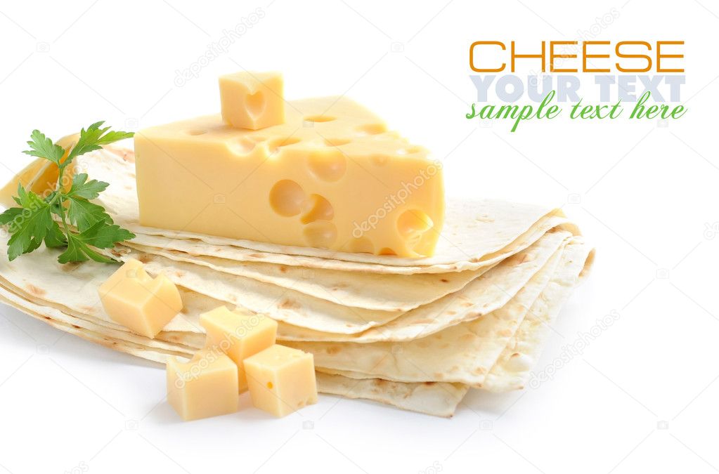 Pieces of cheese are on a pita on a white background