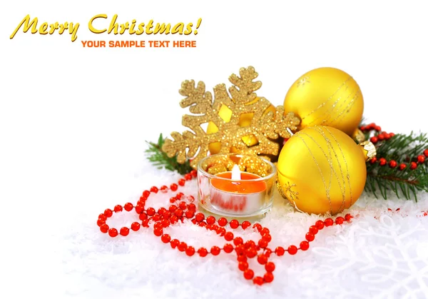 Christmas composition is with gold balls, candle on snow — Stock Photo, Image