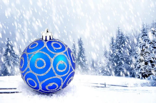 Blue christmas ball on winter landscape — Stock Photo, Image