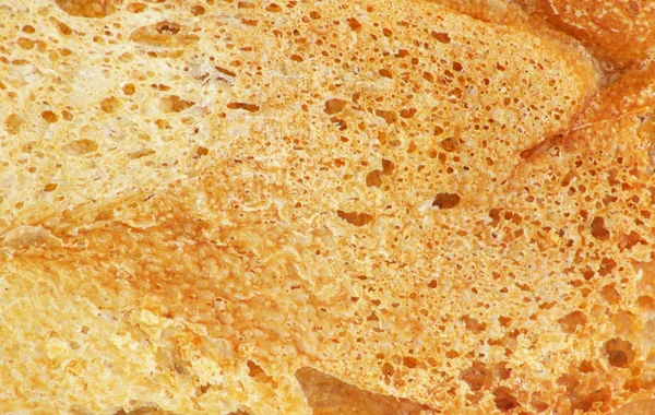 Croûte de pain comme toile de fond. Macro — Photo