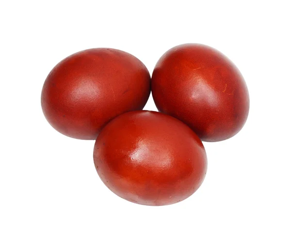 Три червоні великодні яйця на білому тлі — стокове фото