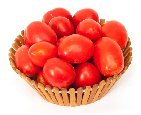 stock image Fresh tomatoes on green branch in wicker basket isolated on whit