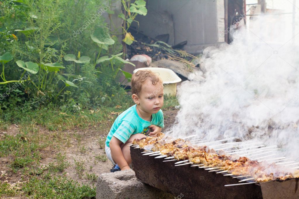 Boy cooks barbecue